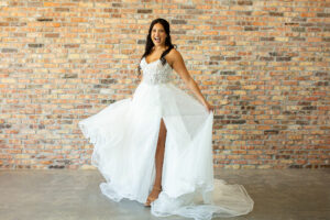 A bride modeling a white lace wedding dress