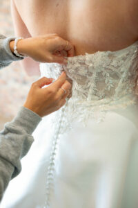 A bride being fitted for the Chloe dress, a strapless ivory A line dress.