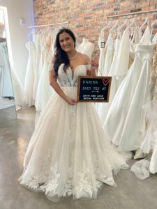 Satin & Lace Bride, Karina, wearing her wedding dress and holding the "I said Yes" board.