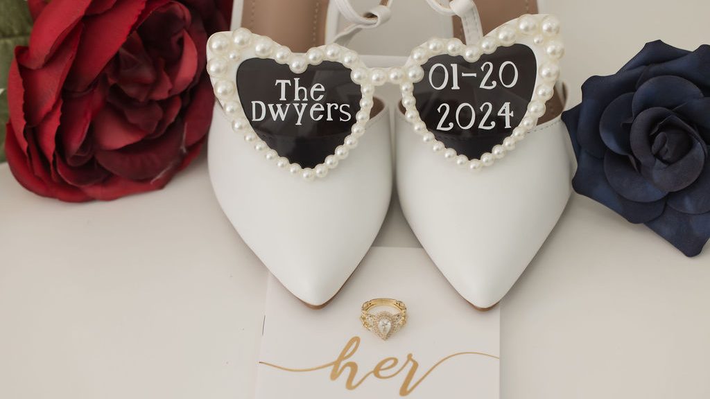 Heart-shaped sunglasses, paired with wedding shoes and a vows book, capturing a fun and romantic moment for a Valentine’s-themed wedding in Riverview, FL. A playful and stylish accessory set that adds a personal touch to the bride’s special day.
